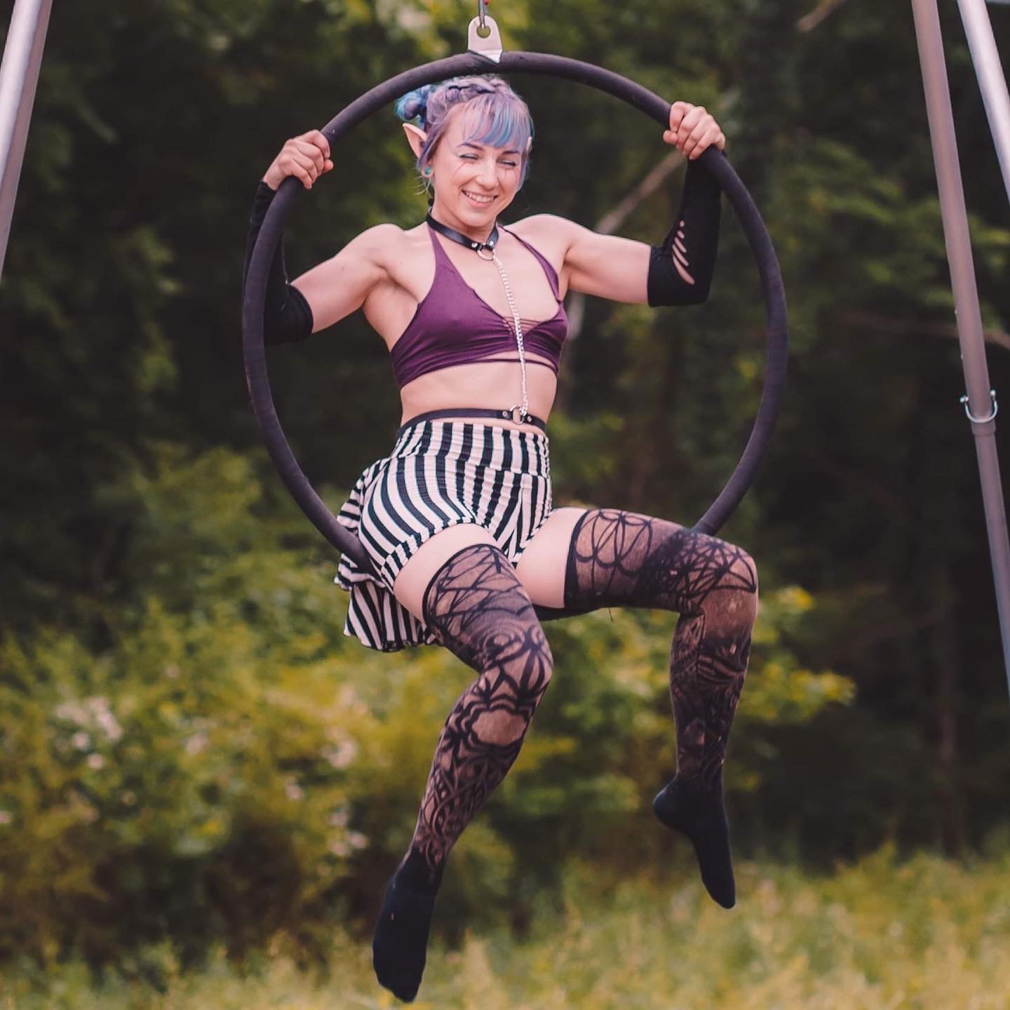 Aerialist inside aerial hoop or lyra smiling
